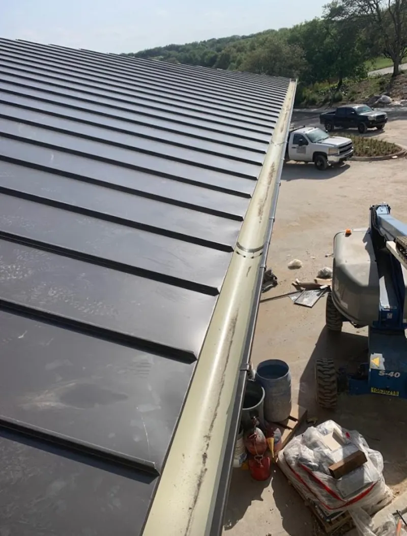 Standing seam panel and gutter detail on a metal roofing jobsite in Alameda